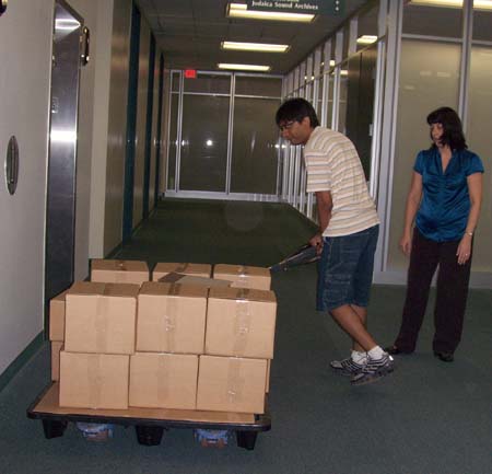 Removing boxes from elevator on Wimberly Library's 5th floor