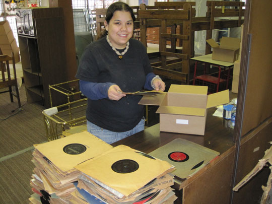Alethea Perez packing phonograph records in store.